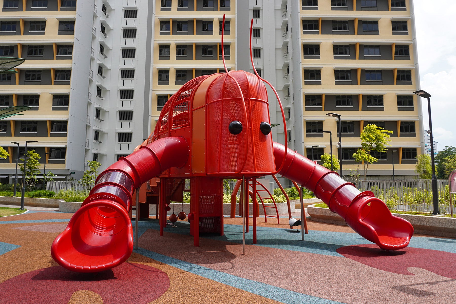 Costa Grove playground with red lobster-themed play equipment, claw slides and climbing structures for safe fun play.