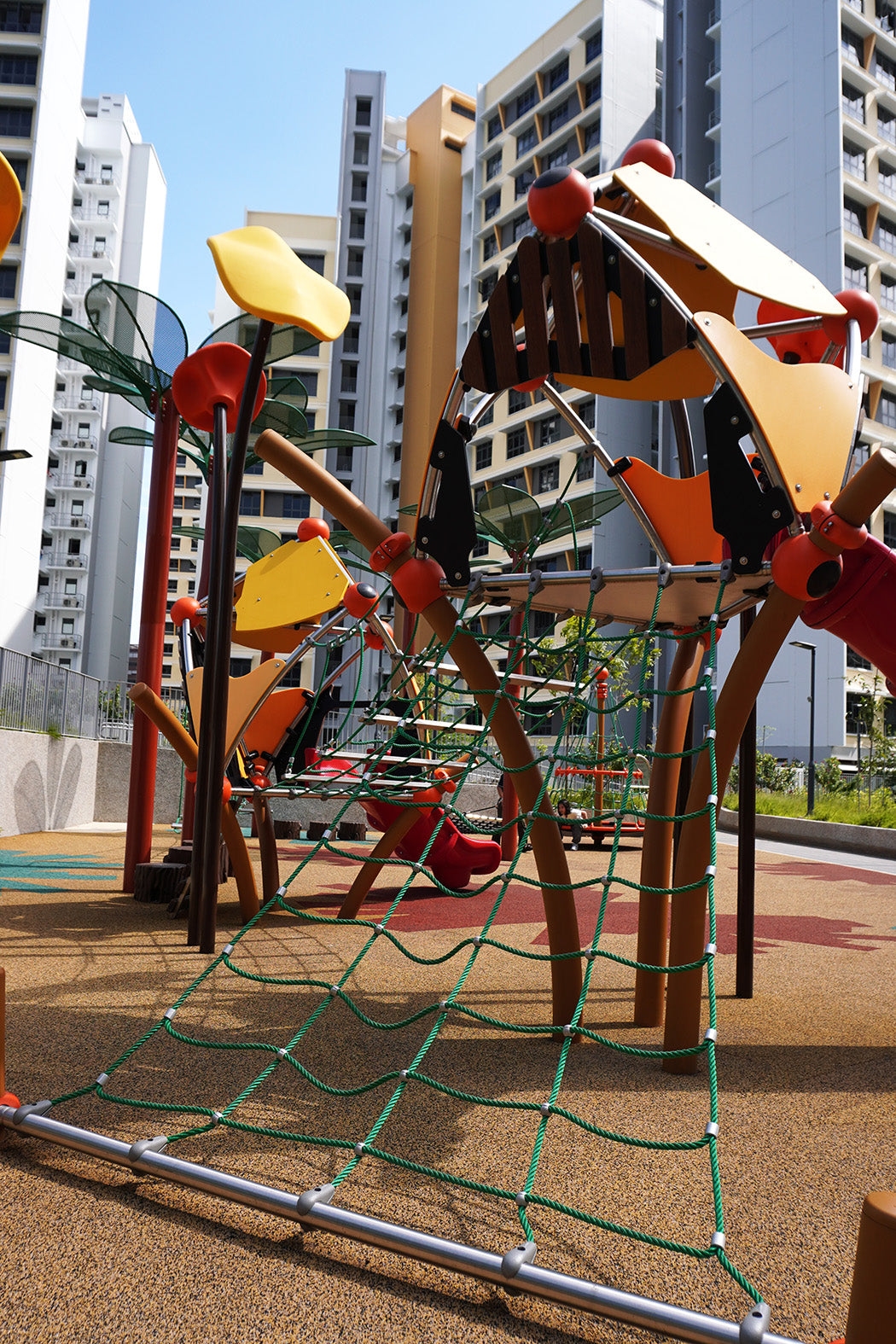 Berliner Greenville play towers are linked by a rope bridge with slides and climbing routes for active play.