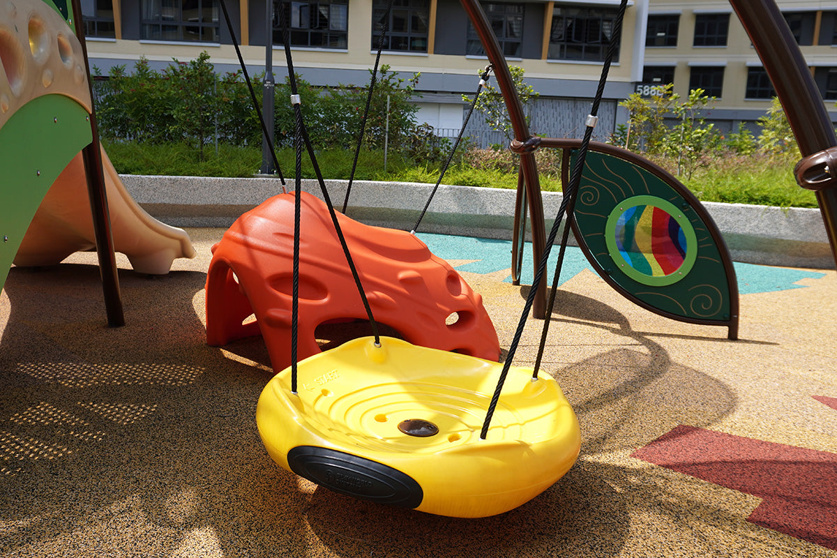 Bambino's circular swing with enclosed seating designed for gentle motion play within a safe and secure play zone.