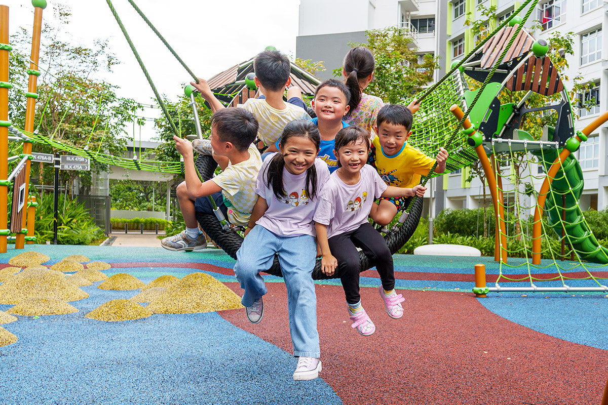 Children on a Berliner Palmetto Saucer swing, promoting teamwork and cooperation while enjoying shared play and fun.