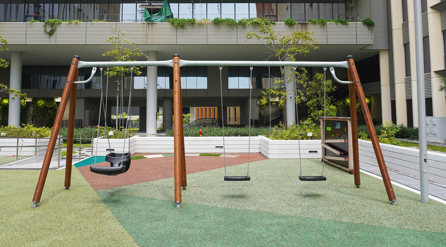 Punggol Digital District playground features individual swings and a tandem swing for adult and child shared play.