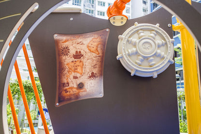 Treasure map and interactive wagon wheel on a pirate ship-themed playground at Punggol Topaz for imaginative play.