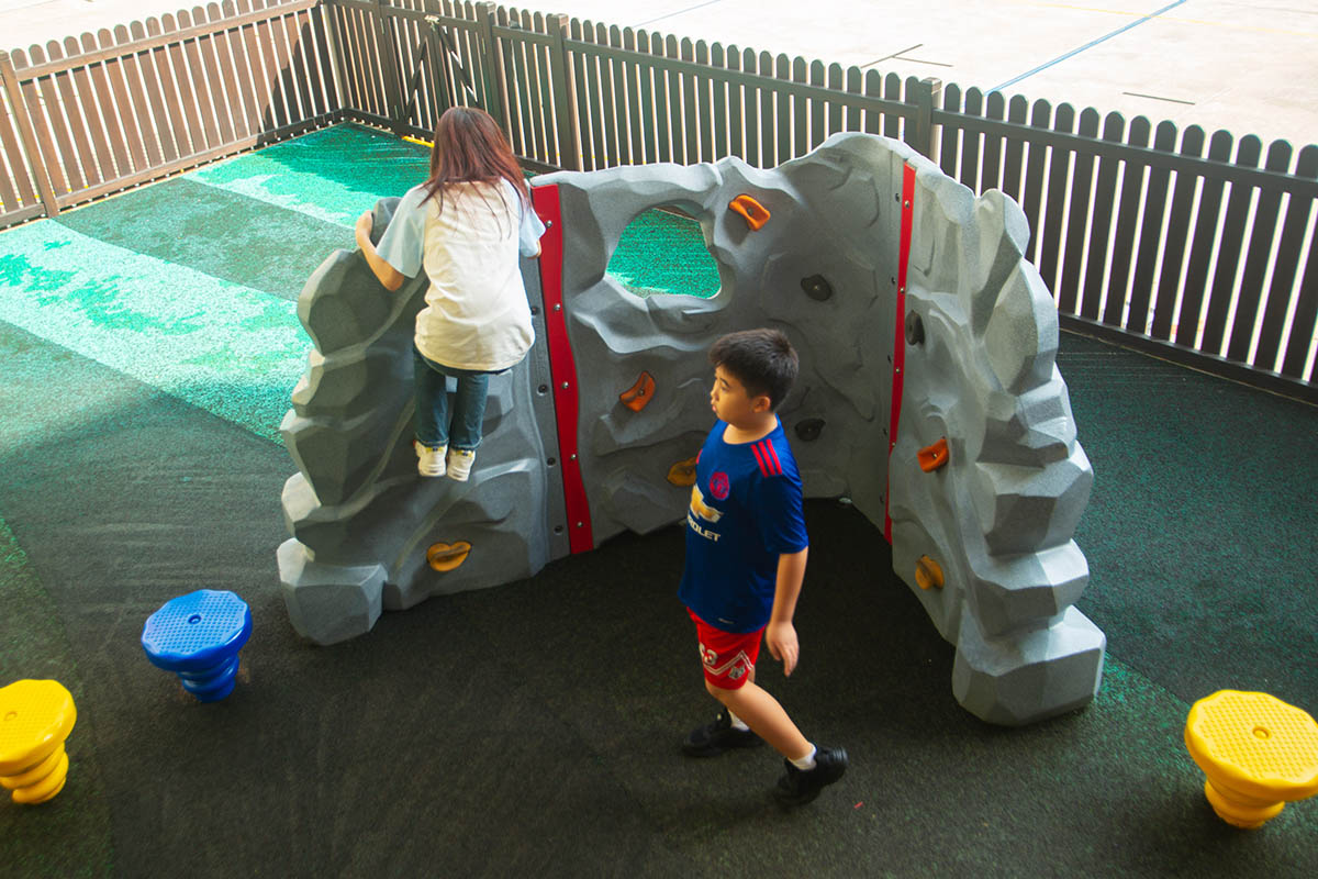 Playworld Corner Rock with finger-friendly handholds and textured surfaces, promoting grip and climbing skills.