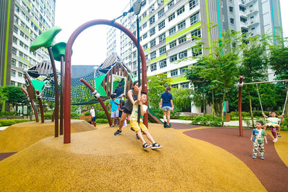 Child riding a zipline at a playground, designed with safety features for a fun and secure outdoor play experience.