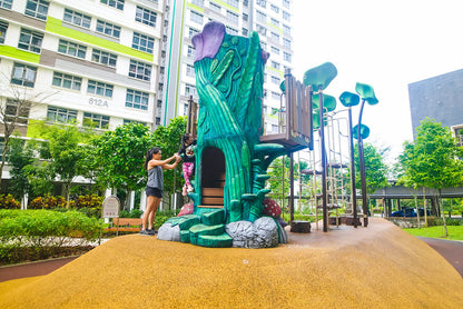 Treehouse-inspired playground with a child climbing, featuring climbing elements for adventure and imaginative play.