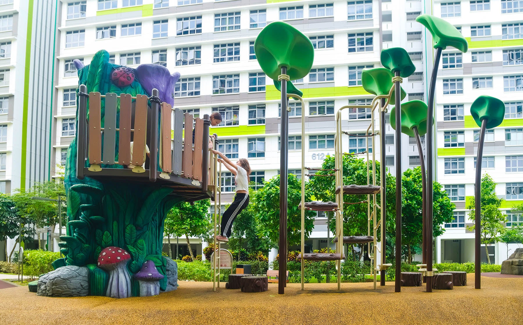 A girl is climbing up the playground stairs, focused and excited to reach the top.