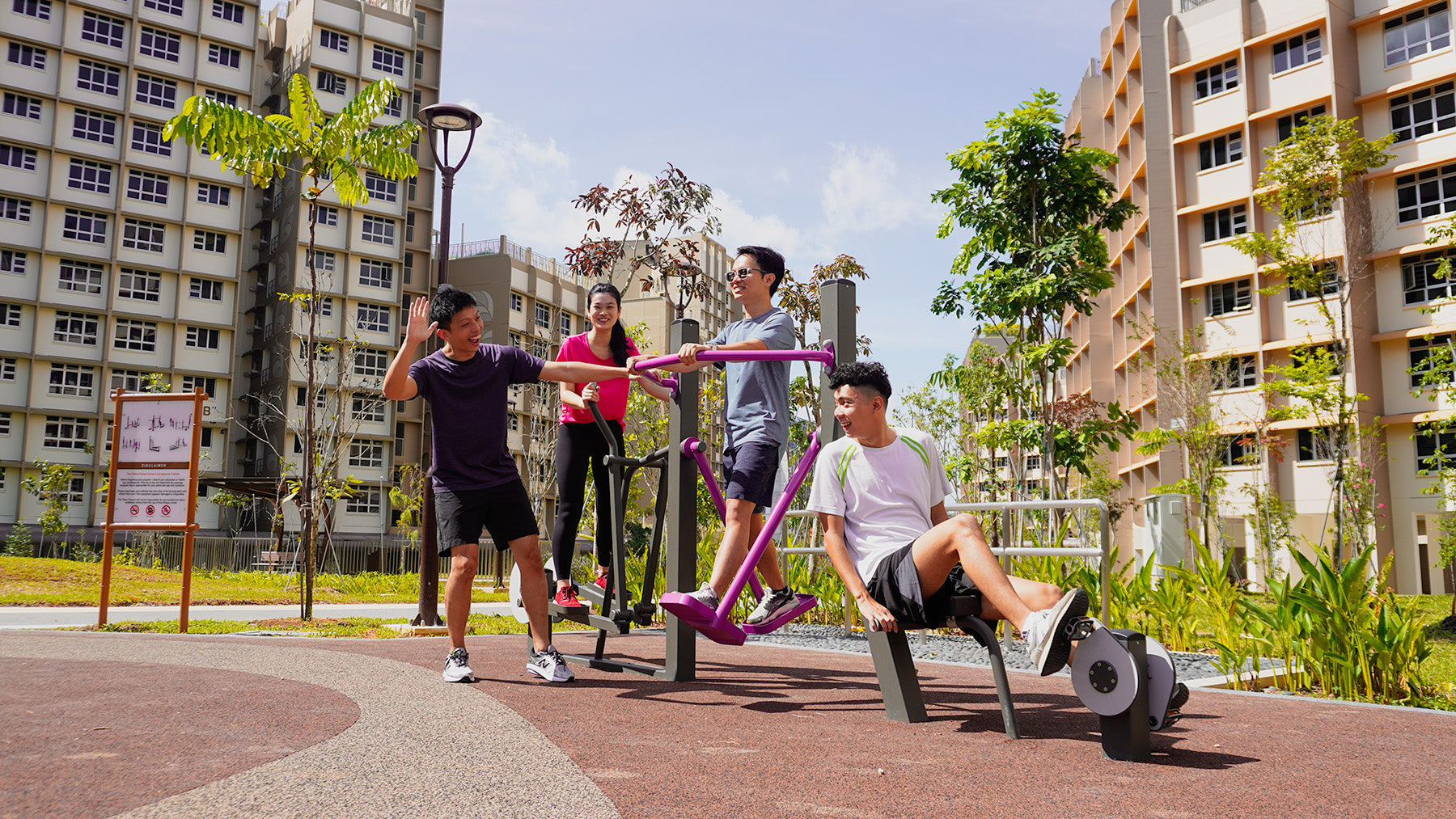 Several people using Galopin exercise equipment, smiling joyfully in a lively and vibrant fitness space.