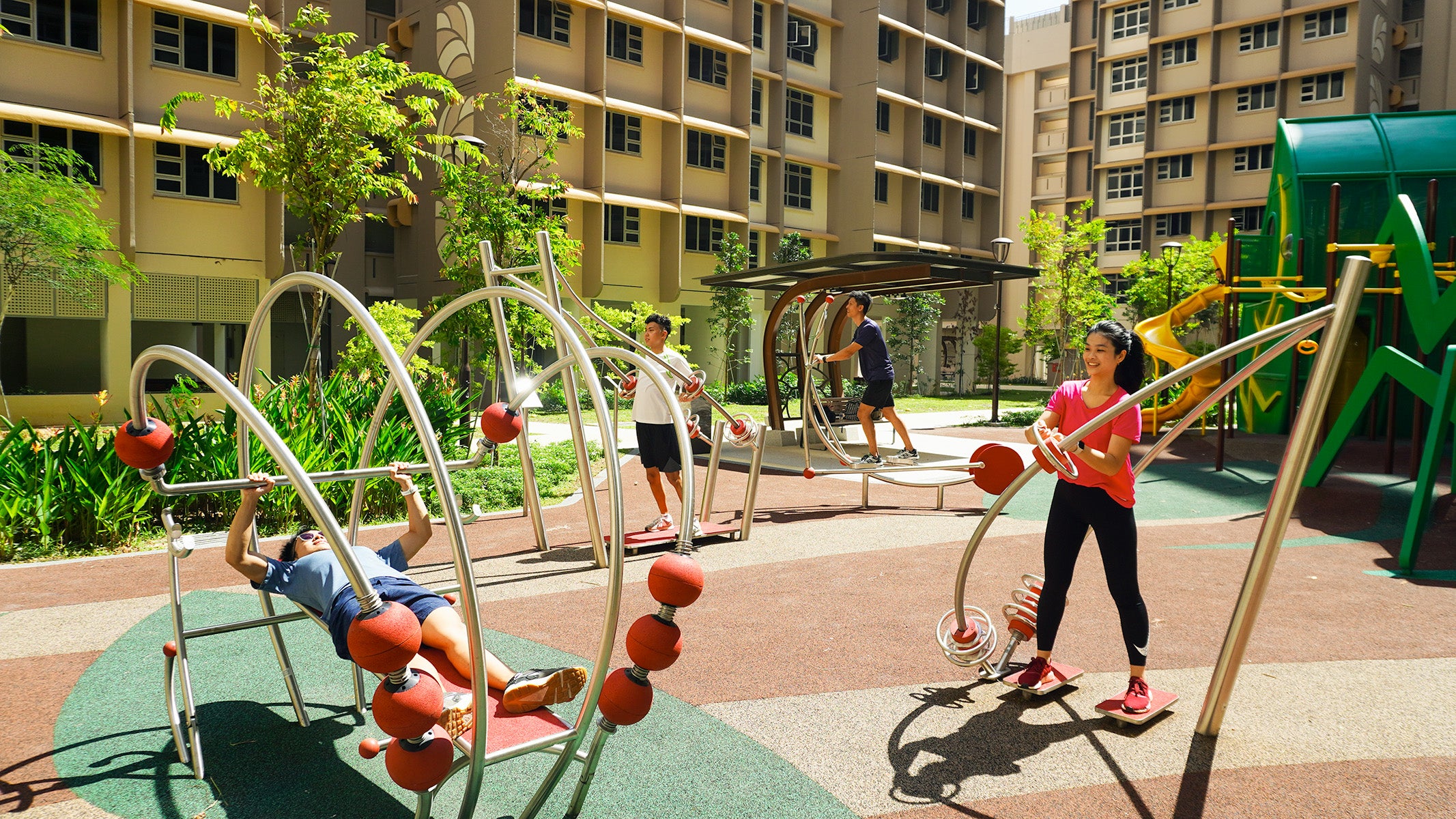 Several people smiling while utilising Stilum fitness equipment, which provides a comprehensive full-body workout.