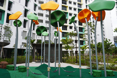 Tengah Parc Clover playground features several LolliTop, tree-like support poles to protect children from the sun.