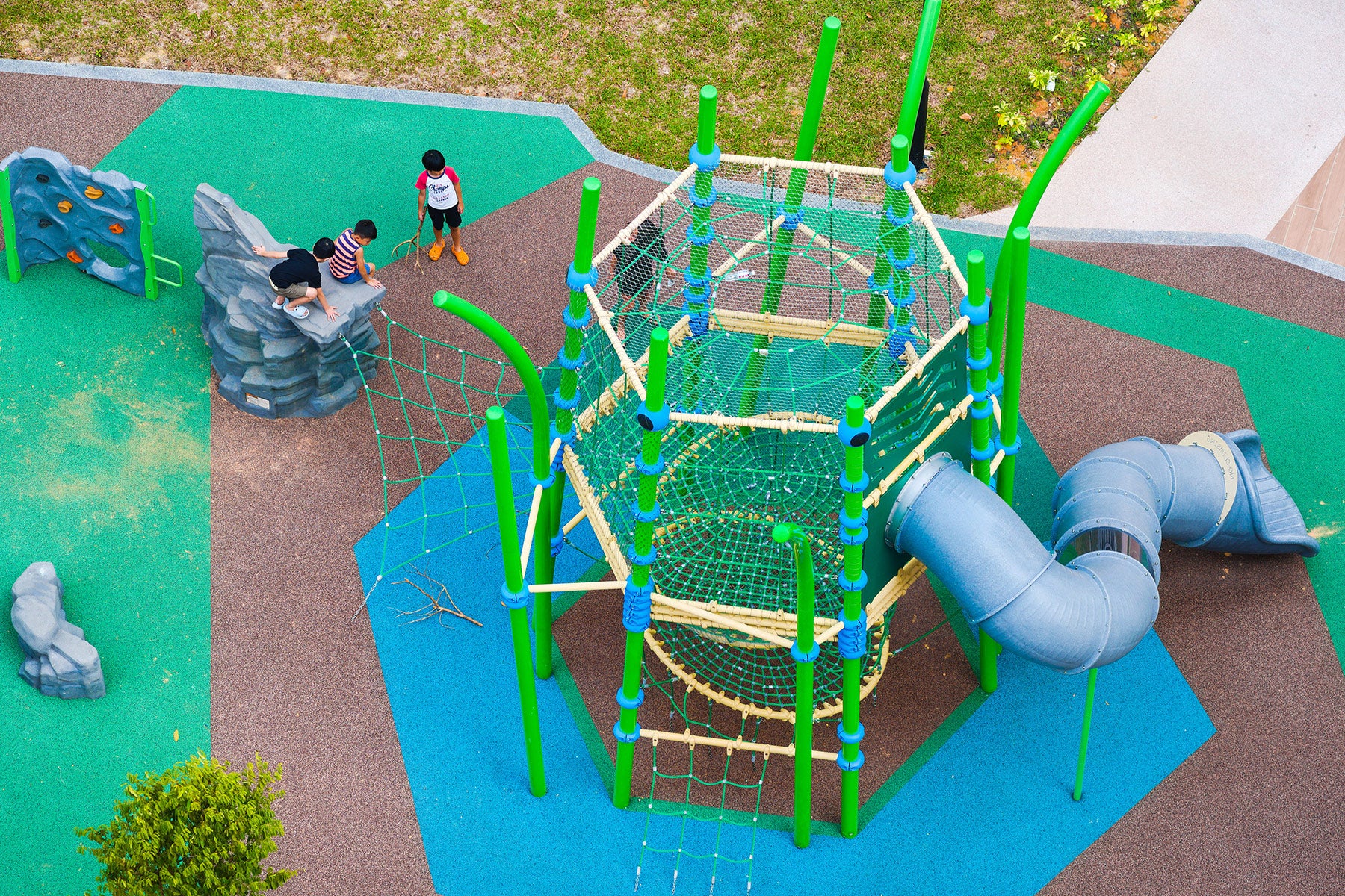 A few children enjoy the challenge of the rock climbing wall, having fun while improving their skills.