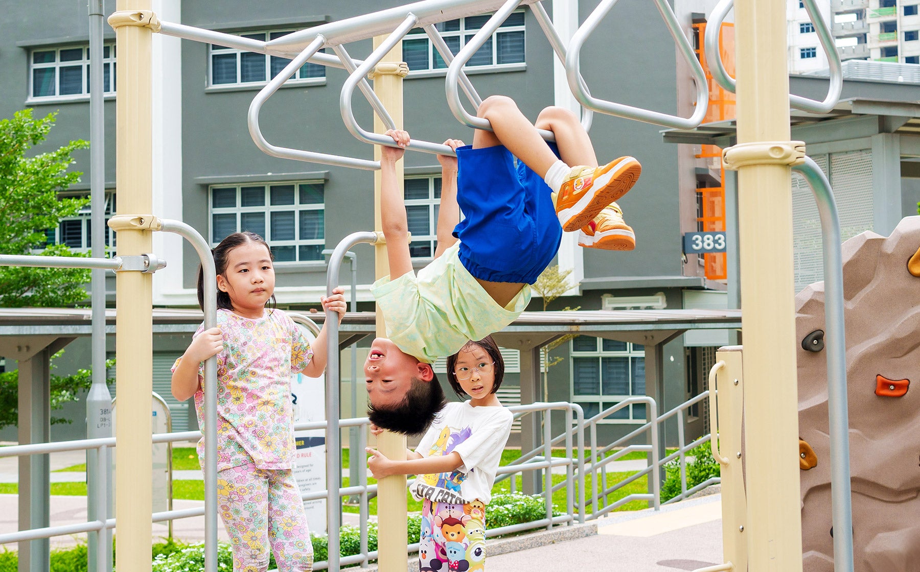 Boy playing at Yishun Glen playground on Playworld monkey bars, boosting agility, strength, and confidence.